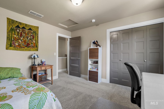 bedroom with attic access, baseboards, visible vents, carpet, and a closet
