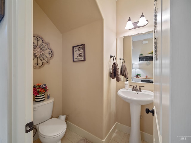 bathroom with tile patterned flooring and toilet