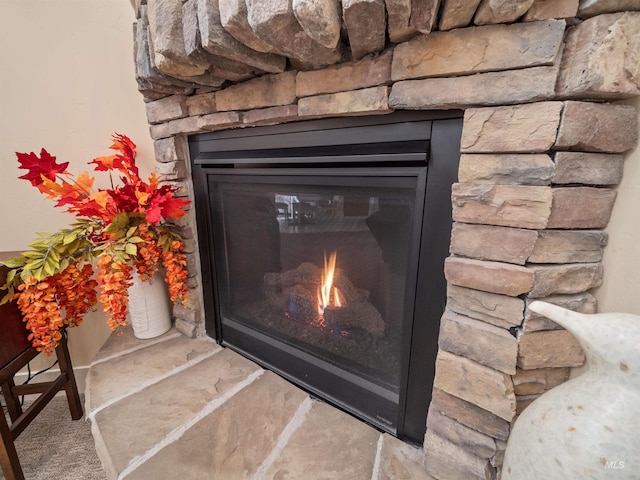 interior details with a stone fireplace