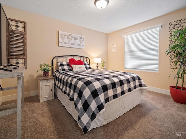 bedroom with carpet and a textured ceiling