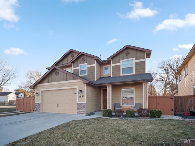 craftsman-style home with a garage and a front lawn