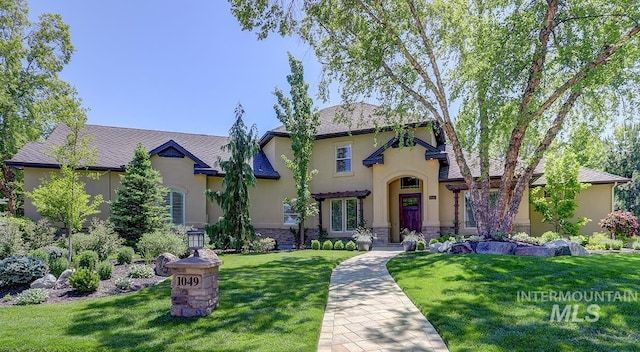 1049 E Riversong Dr, Eagle, ID 83616 - view of front of property with stucco siding, a front yard, and stone siding