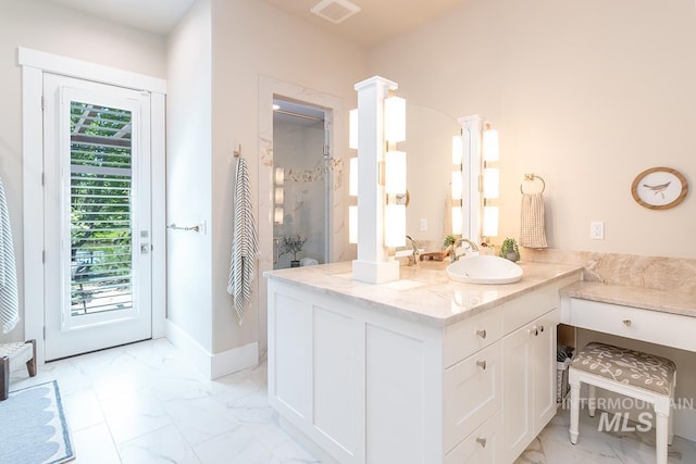 1049 E Riversong Dr, Eagle, ID 83616 - bathroom featuring marble look tiles, walk in shower, vanity, and decorative columns