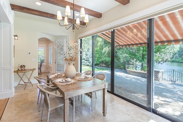 1049 E Riversong Dr, Eagle, ID 83616 - dining space with arched walkways, beamed ceiling, plenty of natural light, a chandelier, and recessed lighting