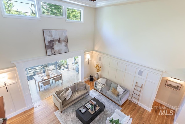 1049 E Riversong Dr, Eagle, ID 83616 - living room featuring light wood-style floors, a decorative wall, and a high ceiling