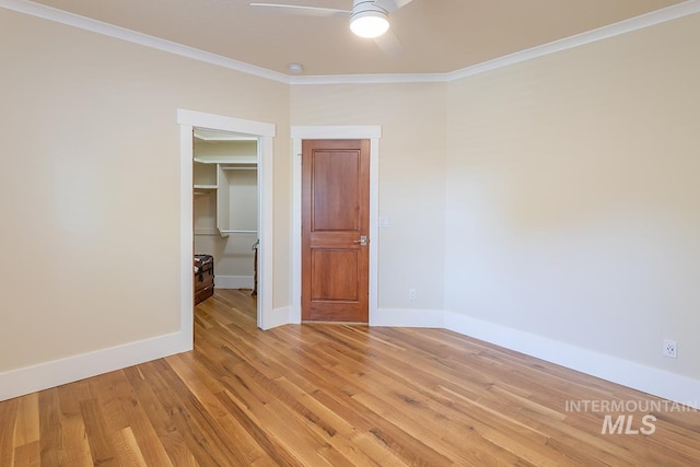 1049 E Riversong Dr, Eagle, ID 83616 - spare room featuring a ceiling fan, ornamental molding, light wood-style floors, and baseboards