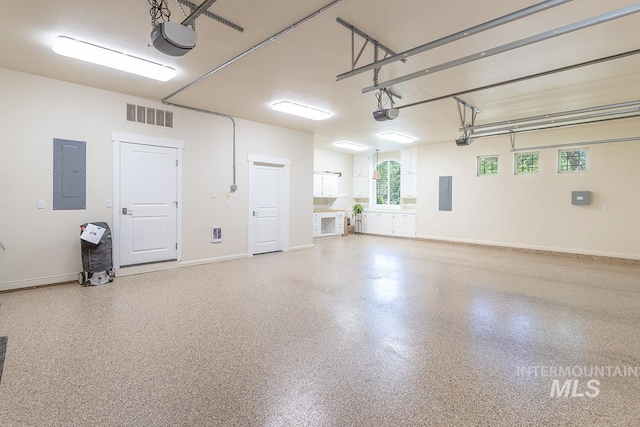 1049 E Riversong Dr, Eagle, ID 83616 - garage with electric panel, a garage door opener, and baseboards