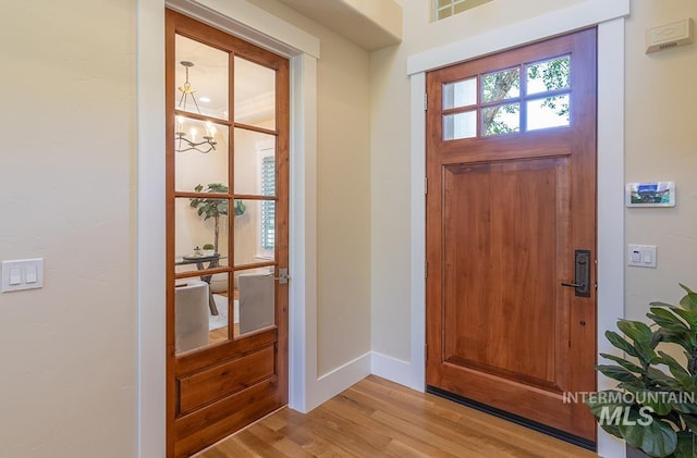 1049 E Riversong Dr, Eagle, ID 83616 - entrance foyer with a chandelier, light wood-style floors, and baseboards