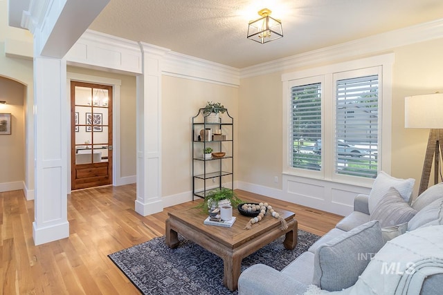 1049 E Riversong Dr, Eagle, ID 83616 - living room with arched walkways, light wood-type flooring, crown molding, and ornate columns