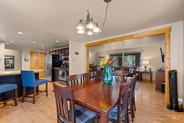 305 Gabi Ln, Mccall, ID 83638 - dining room with light wood-type flooring, a chandelier, recessed lighting, and a textured ceiling