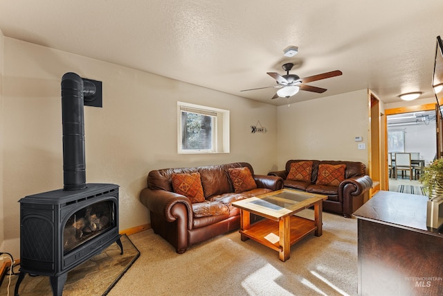 305 Gabi Ln, Mccall, ID 83638 - living area with light colored carpet, a wood stove, and a ceiling fan