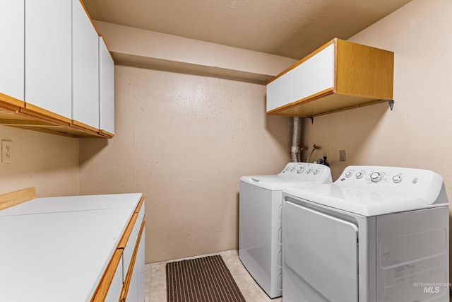 305 Gabi Ln, Mccall, ID 83638 - clothes washing area with washer and dryer, light tile patterned floors, and cabinet space