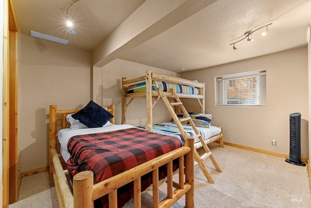 305 Gabi Ln, Mccall, ID 83638 - bedroom with baseboards, light colored carpet, and track lighting