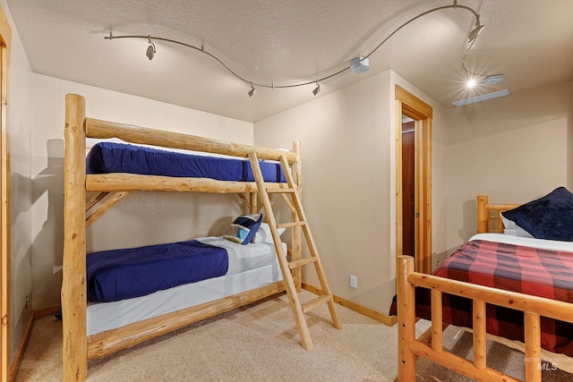 305 Gabi Ln, Mccall, ID 83638 - carpeted bedroom featuring baseboards and rail lighting