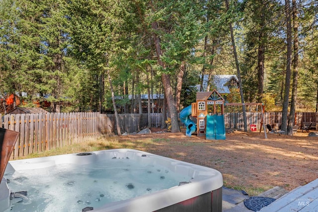 305 Gabi Ln, Mccall, ID 83638 - view of yard with a fenced backyard, a playground, and a hot tub