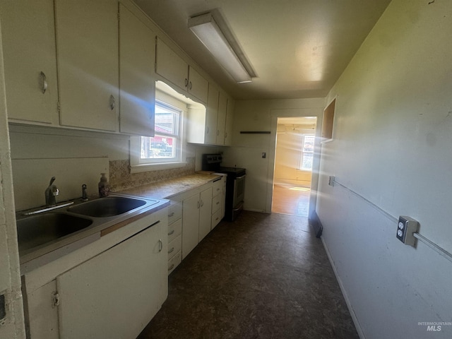 0203 22nd St, Lewiston, ID 83501 - kitchen featuring stainless steel electric range, white cabinets, dark floors, a sink, and light countertops