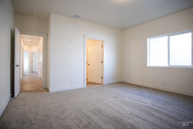 unfurnished bedroom with light colored carpet
