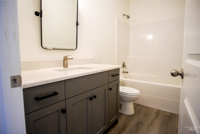 full bathroom featuring vanity, wood-type flooring, toilet, and tub / shower combination