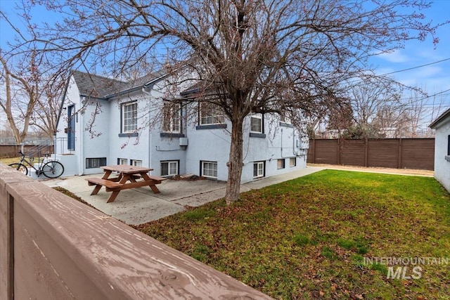 exterior space with a patio area and a yard