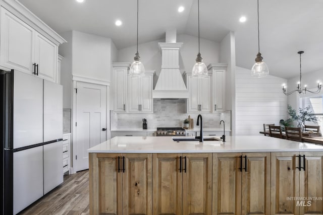 4064 China Ridge Dr, Kimberly, ID 83341 - kitchen with freestanding refrigerator, a sink, vaulted ceiling, white cabinets, and light countertops