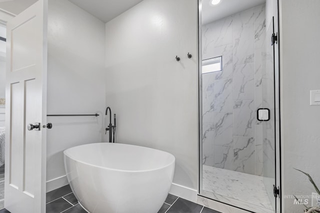 4064 China Ridge Dr, Kimberly, ID 83341 - bathroom featuring a freestanding bath, a marble finish shower, baseboards, and tile patterned floors