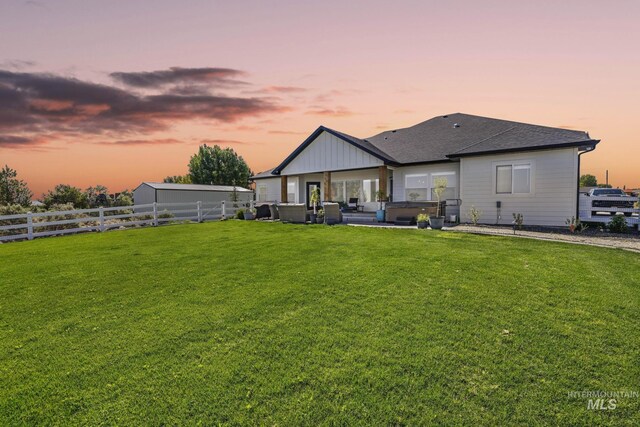 4064 China Ridge Dr, Kimberly, ID 83341 - back of property at dusk with a patio, a hot tub, and a shingled roof