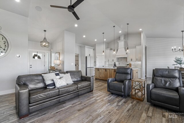 4064 China Ridge Dr, Kimberly, ID 83341 - living area featuring a chandelier, high vaulted ceiling, ceiling fan, wood finished floors, and baseboards
