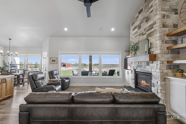 4064 China Ridge Dr, Kimberly, ID 83341 - living room featuring a fireplace, wood finished floors, a ceiling fan, a chandelier, and recessed lighting