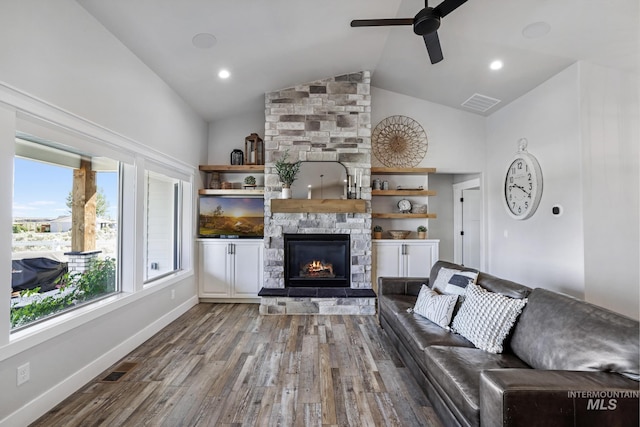4064 China Ridge Dr, Kimberly, ID 83341 - living area featuring ceiling fan, wood finished floors, a stone fireplace, high vaulted ceiling, and baseboards