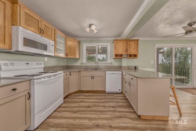 2445 Orchard Rd, Council, ID 83612 - kitchen with white appliances, a peninsula, crown molding, light wood finished floors, and a breakfast bar area