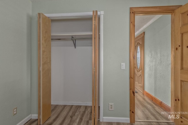 2445 Orchard Rd, Council, ID 83612 - unfurnished bedroom with wood finished floors, a closet, baseboards, and ornamental molding