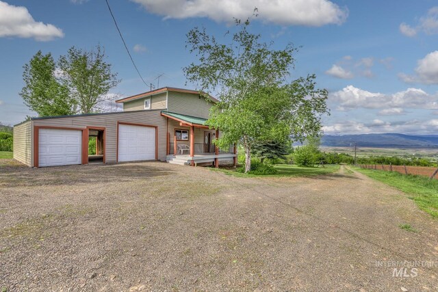2445 Orchard Rd, Council, ID 83612 - view of front facade with a garage, driveway, and a mountain view
