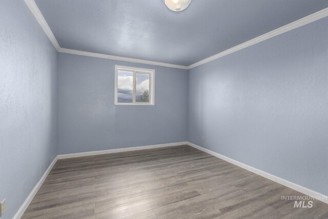2445 Orchard Rd, Council, ID 83612 - unfurnished room with ornamental molding, wood finished floors, and baseboards
