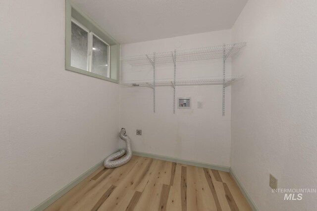 2445 Orchard Rd, Council, ID 83612 - laundry area featuring washer hookup, light wood-style floors, baseboards, and hookup for an electric dryer