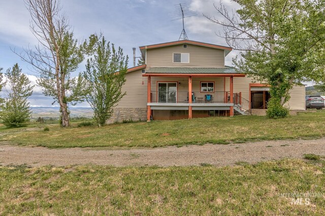 2445 Orchard Rd, Council, ID 83612 - back of house featuring a porch, a yard, and metal roof