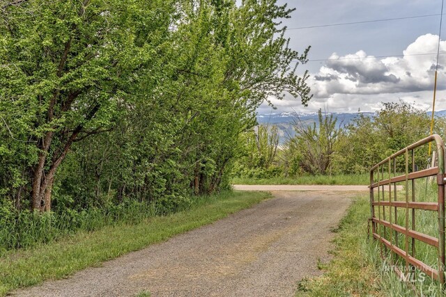 2445 Orchard Rd, Council, ID 83612 - view of road featuring a wooded view and a gated entry