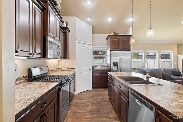 2448 Village St, Twin Falls, ID 83301 - kitchen with stainless steel appliances, a sink, dark wood-type flooring, dark brown cabinetry, and vaulted ceiling