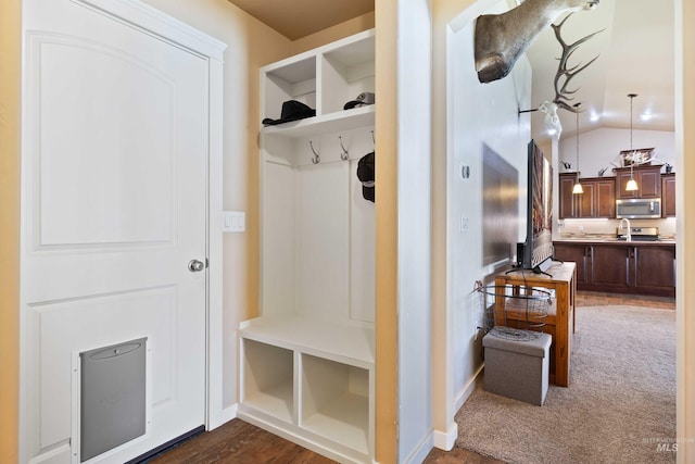 2448 Village St, Twin Falls, ID 83301 - mudroom featuring lofted ceiling, dark colored carpet, and baseboards