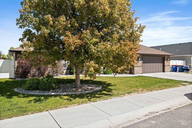 2448 Village St, Twin Falls, ID 83301 - view of property hidden behind natural elements with driveway, stone siding, an attached garage, and a shingled roof