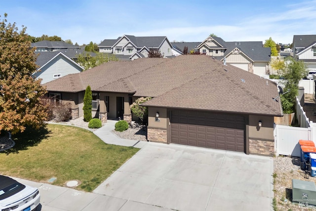 2448 Village St, Twin Falls, ID 83301 - view of front of property featuring stone siding, a residential view, a garage, and driveway