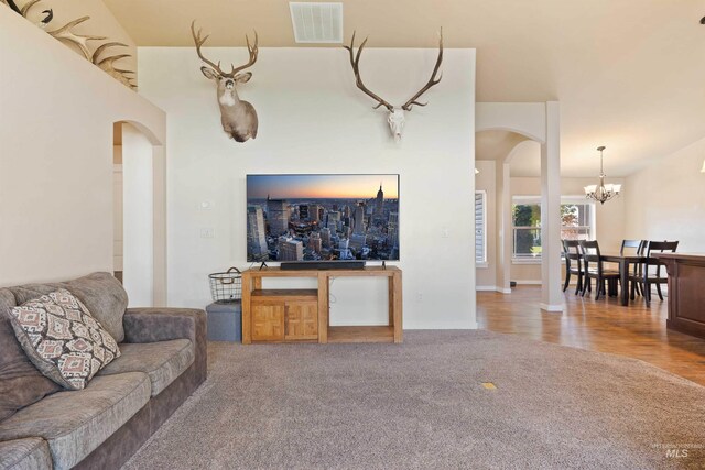 2448 Village St, Twin Falls, ID 83301 - carpeted living area with arched walkways and a chandelier
