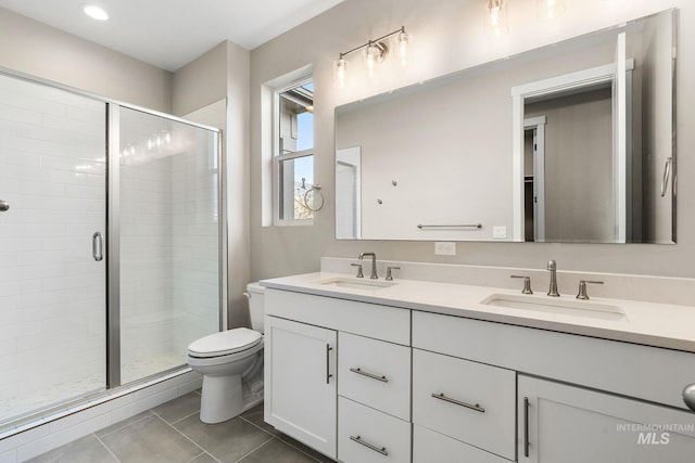 full bath featuring double vanity, tile patterned flooring, a sink, and a shower stall