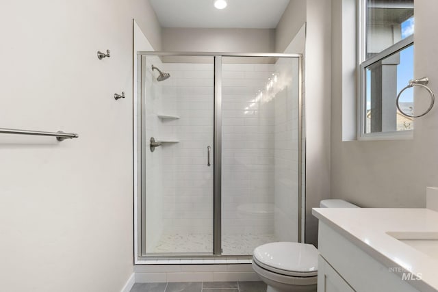 bathroom featuring a shower stall, vanity, and toilet