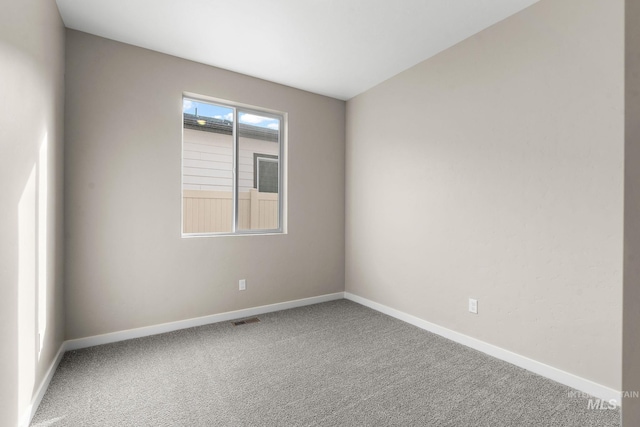 unfurnished room featuring carpet floors, baseboards, and visible vents