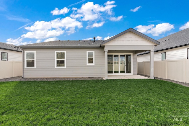 back of house with a patio area, a fenced backyard, and a yard