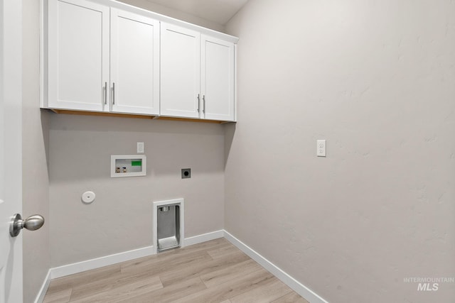 washroom featuring hookup for a washing machine, cabinet space, light wood-style floors, electric dryer hookup, and baseboards