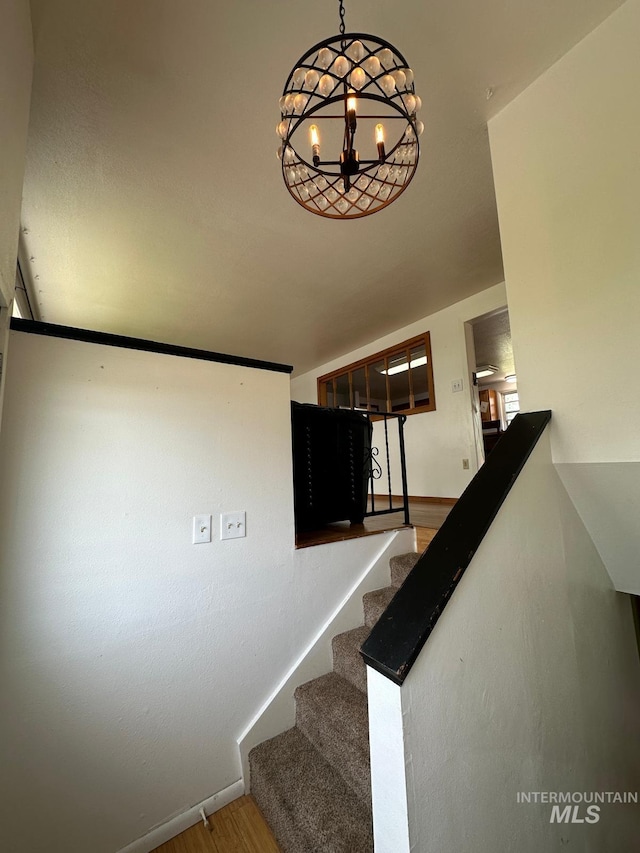 812 Thompson Ave, Nyssa, OR 97913 - stairs featuring wood finished floors, a chandelier, and baseboards