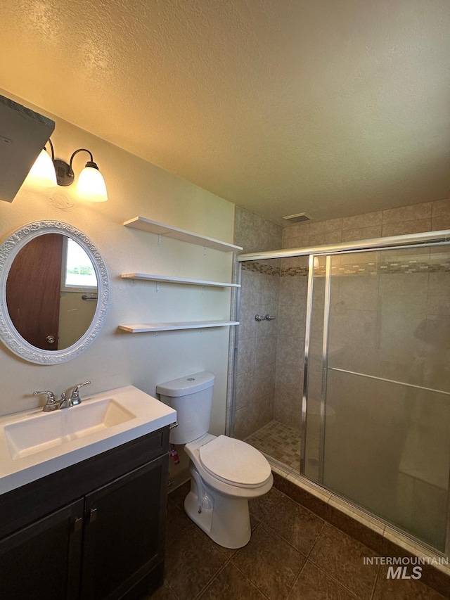 812 Thompson Ave, Nyssa, OR 97913 - full bath with a stall shower, toilet, vanity, and tile patterned flooring