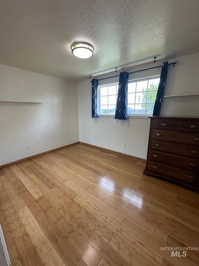 812 Thompson Ave, Nyssa, OR 97913 - spare room with a textured ceiling, hardwood / wood-style floors, and baseboards