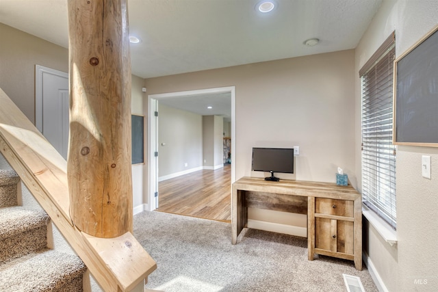 carpeted office space featuring recessed lighting, visible vents, and baseboards